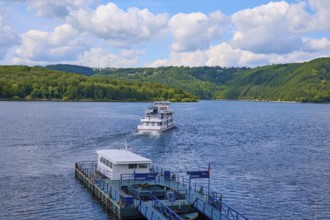 A departing passenger ship, on a large lake under a cloudy sky, summer, Rursee, Rurtalsperre,