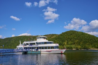 Passenger ship at the jetty, surrounded by green hills and blue sky, summer, Rursee, Rurberg,