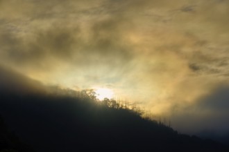 Sunset behind mountains, surrounded by fog and clouds, summer, Rursee, Obersee, Rurberg, Simmerath,