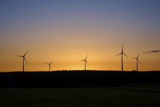 Wind turbines in front of an orange-coloured sunrise, Rohren, Monschau, Eifel, North