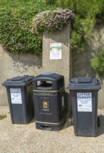 Litter rubbish waste bins and notice about littering fines, Southwold, Suffolk, England, UK