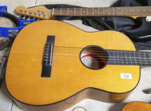 Acoustic guitar viewed from above on display at auction, UK