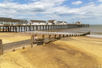 Wooden groyne running down sandy beach near pier, Southwold, Suffolk, England, UK
