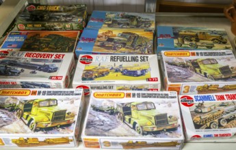 Boxes of Matchbox and Airfix military vehicles scale models on display at auction, UK