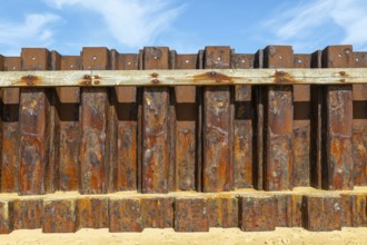 Old rusty steel sheet piling sea wall coastal defence, River Deben, Bawdsey, Suffolk, England, UK