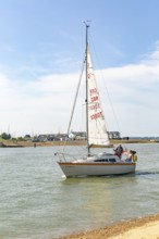 Sailing boat yacht at mouth of River Deben estuary, Bawdsey Quay, Suffolk, England, UK