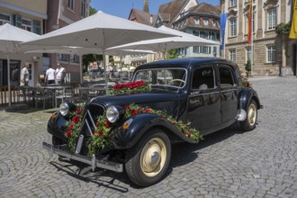 A Citroen 11CV Traction vintage car, built between 1934 and 1957 with floral decorations, wedding