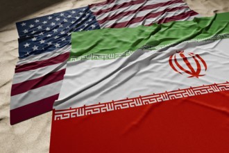 American and Iranian flags resting on desert sand