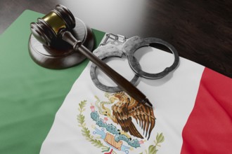 Gavel and handcuffs resting on mexican flag