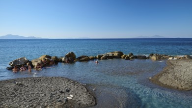 Rocks in clear blue sea, calm coastal landscape in sunshine, Embros Thermal Baths, Kos, Dodecanese,