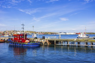 Picturesque scenery of small tugboats in the harbour of Lysekil, BohuslÃ¤n, VÃ¤stra Götalands lÃ¤n,