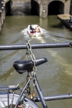 Cycling in the Netherlands, Utrecht, bicycle secured with a chain of steel links on a bridge over a