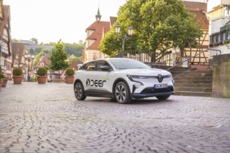 A vehicle in an urban landscape with half-timbered houses, Deer E, car sharing, electric car, Calw,