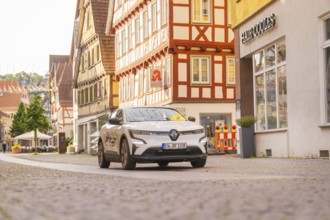 A car in a historic street with half-timbered houses, Deer E, car sharing, electric car, Calw,