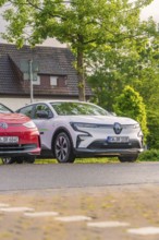 Two cars parked in front of a house in a green, quiet residential area, Deer E, car sharing,