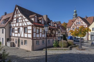 Historic half-timbered houses in the old town, tower of St. John's Church in the back, Lauf an der