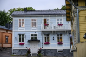 Street scene in the old town of Naantali, two-story light blue wooden house with balconies