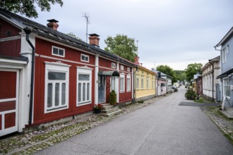 Street scene in the old town of Naantali, colorful traditional buildings on a paved, quiet street,