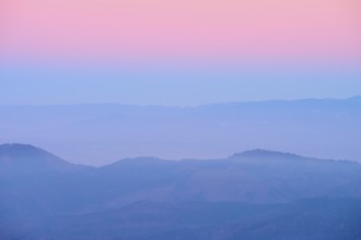 Foggy mountains spreading out under a pink sky, sunset, looking towards the Rhine Valley, Hohneck,