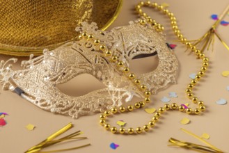 Golden mask with pearls, hat and confetti, carnival