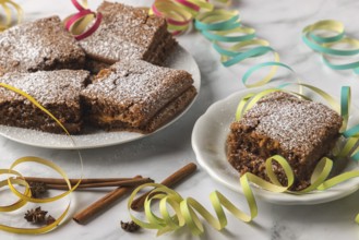 Spice cake with powdered sugar surrounded by colorful streamers