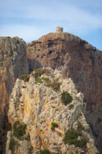 Bizarre rock formations on Capo Rosso, a Genoese tower blurred in the back, Piana, Corse-du-Sud