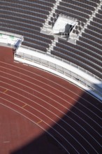 Modern stadium stand with empty seats, outdoor stairs and tartan track, Helsinki Olympic Stadium,