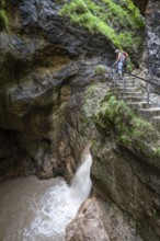 Woman hiking in the Almbach Gorge, Berchtesgaden Biosphere Reserve, Almbach, Berchtesgaden Alps,