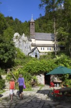 Mother and daughter in front of Maria Klobenstein pilgrimage church, Kössen, Austria