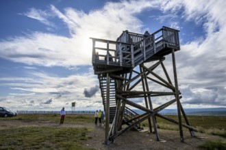 Wooden observation tower in a vast landscape under a partly cloudy sky, Kaunispää Caabuaivas,