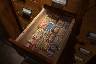 Historical matchbox labels, various motifs, in wooden drawer, Tändsticksmuseet matchstick museum or