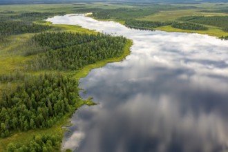 Sodankylä, Lapland, Finland, A calm river snakes through a thick forest, the clouds are reflected