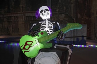 Death plays guitar, illuminated scary figure at Halloween Run, Landschaftspark Duisburg-Nord,
