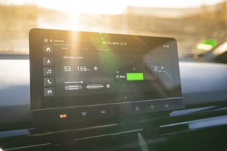 Modern car display provides information about fast charging, embedded in stylish interior, MG4