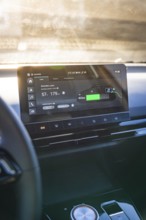 Modern car display with charging information and user interface in sunlight, MG4 electric car, Deer