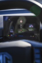 Electronic dashboard shows driving information and battery status in a modern car, MG4 electric