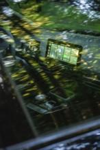 Car interior with reflective tree reflections and modern display on screen, MG4 electric car, Deer