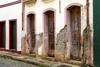 Houses in old colonial architecture with their facades worn by time in the city of Ouro Preto,