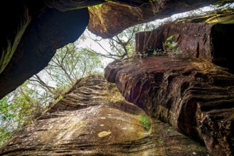 A rock wall overlooking the forest inside a cave on the outskirts of the city of Ouro Preto in
