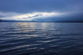 Misty morning atmosphere at the lake with Schafberg, Mondsee, Salzkammergut, Upper Austria, Austria
