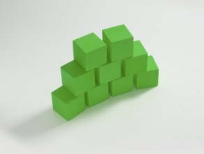 9 green wooden cubes against a white background