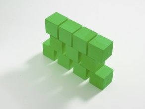 11 green wooden cubes against a white background