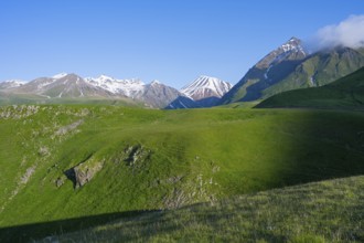Green landscape with a vast expanse of mountains and snow-capped peaks, landscape between Kvesheti