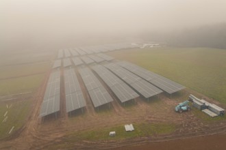 Solar systems in fields in foggy surroundings, distinct structure of solar modules, energy