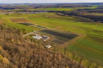 Panorama of a landscape with solar plant, forests and village in an autumn environment, energy