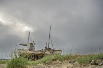 An old fishing boat on the beach of the Varangerfjord, Vestre Jacobselv, Finnmark, Norway