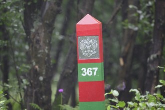 A colorful border post border marker on the Jacobselv river on the Russian side of the