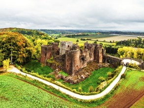 Autumn Colours over ruins of Goodrich Castle and River Wye from a drone, Goodrich, Herefordshire,