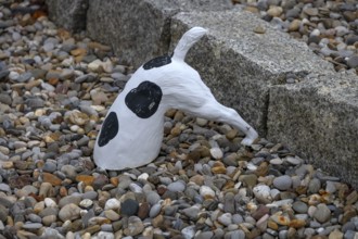 Dog figure with head in a stone bed, Franconia, Bavaria, Germany
