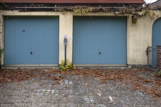 Parking meter between two garages, Bavaria, Germany